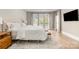 Serene main bedroom featuring a bed with lots of natural light and hardwood floors at 7280 Woodside Ct, Denver, NC 28037