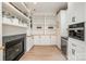 Spacious pantry featuring custom shelving, a cozy fireplace, and a beverage fridge at 7280 Woodside Ct, Denver, NC 28037