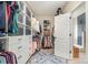 Walk-in closet featuring custom shelving and drawers with access to the bathroom and shower at 7280 Woodside Ct, Denver, NC 28037