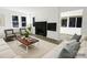 Bright living room features modern decor, black fireplace, hardwood floors, and neutral tones at 751 N Miller Ave, Statesville, NC 28677