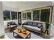 Bright sunroom features neutral decor, hardwood floors, and lots of natural light at 751 N Miller Ave, Statesville, NC 28677