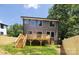 Modern home boasts a new deck, fenced yard, and ample natural light from many windows at 816 Tennyson Dr, Charlotte, NC 28208