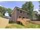 Well-maintained backyard with new wood fence, stairs to the new deck and lush green lawn at 816 Tennyson Dr, Charlotte, NC 28208