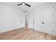This bright bedroom has beautiful floors, a black ceiling fan, and white walls at 816 Tennyson Dr, Charlotte, NC 28208