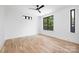 This bright bedroom has beautiful floors, a black ceiling fan, and a view to the outdoors at 816 Tennyson Dr, Charlotte, NC 28208