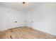 Spacious bedroom with hardwood floors, double doors, neutral walls and ample lighting at 816 Tennyson Dr, Charlotte, NC 28208