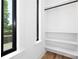 Neat closet space with built-in shelving and a window to let the outdoors in at 816 Tennyson Dr, Charlotte, NC 28208