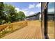 Large wooden deck overlooking a beautiful, fenced yard with lots of green trees at 816 Tennyson Dr, Charlotte, NC 28208
