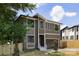 Two-story home featuring a modern design, large windows, stylish wood door, and an attached garage at 816 Tennyson Dr, Charlotte, NC 28208