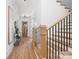 Light-filled foyer with hardwood floors, stairs with black iron railings, and a modern console table at 816 Tennyson Dr, Charlotte, NC 28208