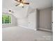 Spacious bedroom featuring carpet, neutral colors, ceiling fans and a window overlooking mature trees at 817 Quince Ct, Indian Trail, NC 28079