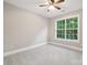 Bright bedroom featuring carpet, neutral colors, and a window overlooking mature trees at 817 Quince Ct, Indian Trail, NC 28079