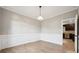 Formal dining room featuring hardwood floors, wainscoting, and a view of the kitchen at 817 Quince Ct, Indian Trail, NC 28079