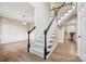 Bright entryway with hardwood floors and a staircase with white railings and dark banisters at 817 Quince Ct, Indian Trail, NC 28079