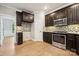 Well-appointed kitchen featuring stainless steel appliances and beautiful dark wood cabinets at 817 Quince Ct, Indian Trail, NC 28079