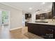 Spacious kitchen featuring granite countertops, dark wood cabinets, and stainless steel appliances at 817 Quince Ct, Indian Trail, NC 28079