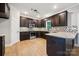Modern kitchen featuring granite countertops, stainless steel appliances, and dark wood cabinetry at 817 Quince Ct, Indian Trail, NC 28079