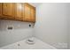 Functional laundry room with ample cabinet space and essential hookups, ready for appliances at 817 Quince Ct, Indian Trail, NC 28079