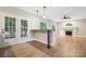 Bright living room boasts a fireplace, bar area with stylish pendant lights, and access to the outdoor deck at 817 Quince Ct, Indian Trail, NC 28079