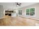 Open-concept living room and kitchen area with stainless appliances, hardwood floors, and generous natural light at 817 Quince Ct, Indian Trail, NC 28079