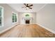 Cozy living room features neutral walls, hardwood floors, a ceiling fan, and a traditional fireplace at 817 Quince Ct, Indian Trail, NC 28079