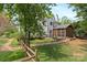 Expansive backyard features a screened in porch and lush landscaping with a stone pathway, ideal for relaxation and outdoor enjoyment at 9101 Strattonville Ct, Huntersville, NC 28078