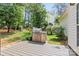 Backyard with a stainless steel barbecue, wood deck, and well maintained landscaping at 9101 Strattonville Ct, Huntersville, NC 28078