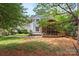 Expansive backyard features a screened in porch and lush landscaping with a stone pathway, ideal for relaxation and outdoor enjoyment at 9101 Strattonville Ct, Huntersville, NC 28078