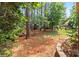 Large backyard with a playground set, a playhouse, and mature trees at 9101 Strattonville Ct, Huntersville, NC 28078