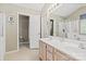 Well-lit bathroom featuring double sinks, updated fixtures, and separate shower and toilet areas at 9101 Strattonville Ct, Huntersville, NC 28078