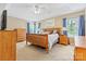 Cozy bedroom with neutral walls, wood furniture set, and plenty of natural light at 9101 Strattonville Ct, Huntersville, NC 28078