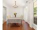 Bright dining room featuring wood floors, wainscoting, chandelier, and natural light from large window at 9101 Strattonville Ct, Huntersville, NC 28078
