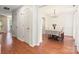 Open-concept dining room with hardwood floors, a chandelier, and views of the living area at 9101 Strattonville Ct, Huntersville, NC 28078