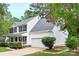 Lovely two-story home with a white exterior, gray roof, attached garage, and manicured landscaping at 9101 Strattonville Ct, Huntersville, NC 28078