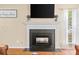 Living room fireplace with decorative mantle, black tile surround, and modern television above at 9101 Strattonville Ct, Huntersville, NC 28078