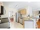 Functional kitchen features stainless appliances, tile floors, and a pass-through breakfast bar at 9101 Strattonville Ct, Huntersville, NC 28078