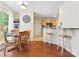Eat-in kitchen features hardwood floors, lots of natural light, and white bar stools at 9101 Strattonville Ct, Huntersville, NC 28078