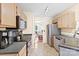 Updated kitchen featuring stainless appliances, tiled floors, and an adjacent dining area at 9101 Strattonville Ct, Huntersville, NC 28078