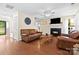Open living room featuring fireplace, hardwood floors, ceiling fan, and easy access to the front yard at 9101 Strattonville Ct, Huntersville, NC 28078