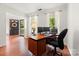 Comfortable home office space with hardwood floors, a desk setup, and plenty of natural light at 9101 Strattonville Ct, Huntersville, NC 28078