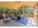 Comfortable seating on the screened-in porch with string lights and a view of the wooded backyard at 9101 Strattonville Ct, Huntersville, NC 28078