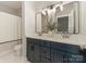 Bathroom features double sink vanity with a marble countertop and large mirror at 10201 Daufuskie Dr, Charlotte, NC 28278