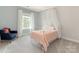 Charming bedroom with a pink bedspread, sheer canopy, blue chair, and window at 10201 Daufuskie Dr, Charlotte, NC 28278