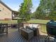 Inviting deck features outdoor seating and a barbecue grill overlooking the lawn at 10201 Daufuskie Dr, Charlotte, NC 28278