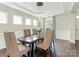 Elegant dining room with a wooden table, plush chairs, and modern lighting at 10201 Daufuskie Dr, Charlotte, NC 28278