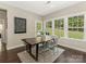 Bright dining room with large windows, hardwood floors, and rustic-style table at 10201 Daufuskie Dr, Charlotte, NC 28278