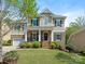Charming two-story home with manicured lawn, stone accents, and a welcoming front porch at 10201 Daufuskie Dr, Charlotte, NC 28278