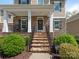Inviting front porch with stone accents, decorative wreath, and wrought-iron railing at 10201 Daufuskie Dr, Charlotte, NC 28278