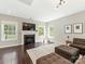Bright living room with a fireplace, large windows, and comfortable seating at 10201 Daufuskie Dr, Charlotte, NC 28278
