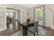 Well-lit office featuring hardwood floors, a modern desk, and decorative curtains at 10201 Daufuskie Dr, Charlotte, NC 28278